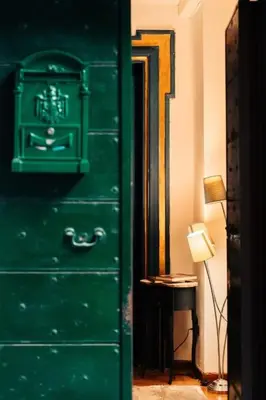 a green dresser in a room with a lamp at Restart Accommodations Lante in Rome