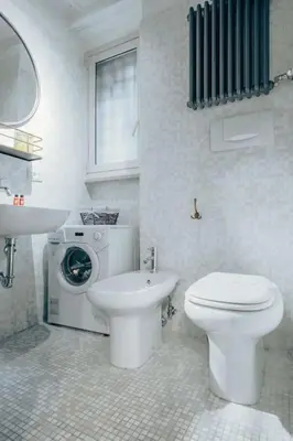a white bathroom with a toilet and a sink at Restart Accommodations Lante in Rome