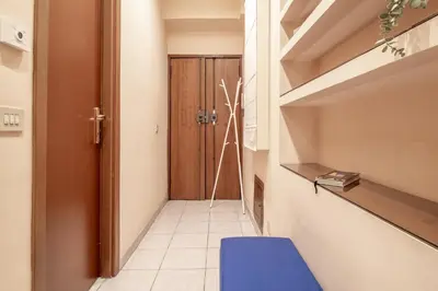 a hallway with a blue chair and a door at Borgo Vittorio 76 in Rome