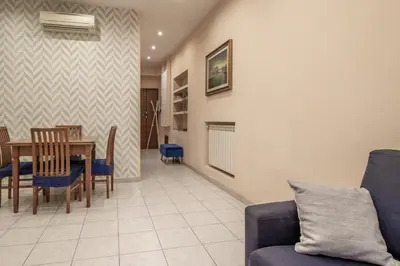 a dining room and living room with a table and chairs at Borgo Vittorio 76 in Rome