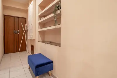 a blue stool in a room with a wall at Borgo Vittorio 76 in Rome