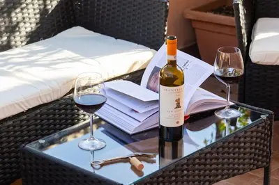 a bottle of wine and two glasses on a table at Centro Piccolo attico da sogno in Rome