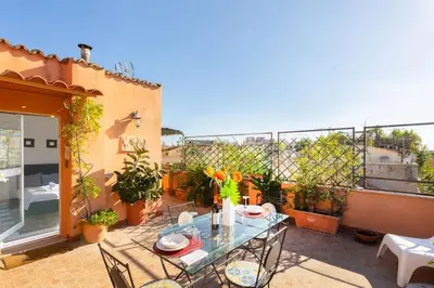 a patio with a table and chairs on a balcony at Centro Piccolo attico da sogno in Rome