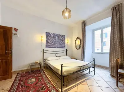 a bedroom with a bed and a rug at Vatican Art Apartment in Rome