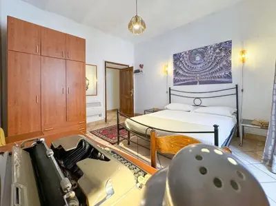 a room with a bedroom with a bed and a table at Vatican Art Apartment in Rome