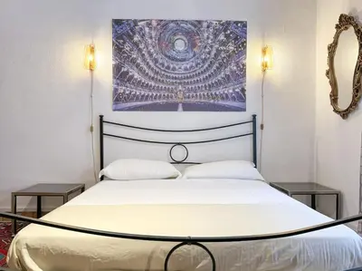 a bedroom with a bed with a painting on the wall at Vatican Art Apartment in Rome