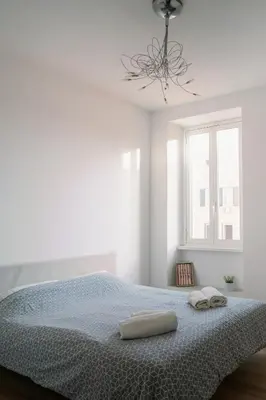 a bedroom with a bed with two towels on it at La Dolce Vita rooms in Rome