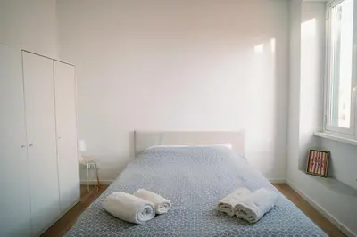 a bedroom with a bed with towels on it at La Dolce Vita rooms in Rome