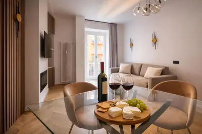 a living room with a table with glasses of wine and cheese at Vatican Boutique - 1 bedroom Apartment - Bilocale in Rome