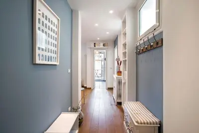 a hallway with blue walls and a bench in it at AndreaSuite Gianicolo in Rome