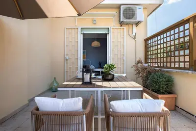 a patio with two chairs and a table at AndreaSuite Gianicolo in Rome