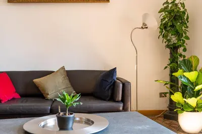 a living room with a couch and a table at Oasi artistica a Trastevere in Rome