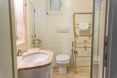 a bathroom with a sink and a toilet at Oasi artistica a Trastevere in Rome