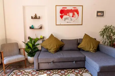 a living room with a couch and a chair at Oasi artistica a Trastevere in Rome