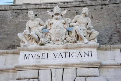 a statue of two men sitting on the side of a building at Deluxe Vatican in Rome