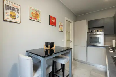 a kitchen with a black table and a stove at Jmartins Vatican Apartment in Rome