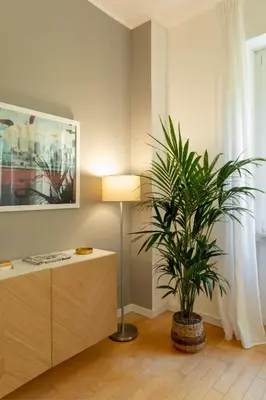 a living room with a lamp and a plant at Casa Porta Metronia in Rome