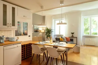 a kitchen and living room with a table and chairs at Casa Porta Metronia in Rome