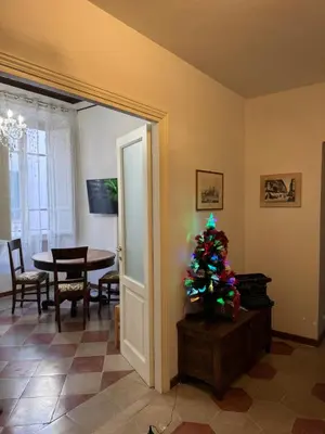 a christmas tree in a living room with a table at Casa Angeli in Rome