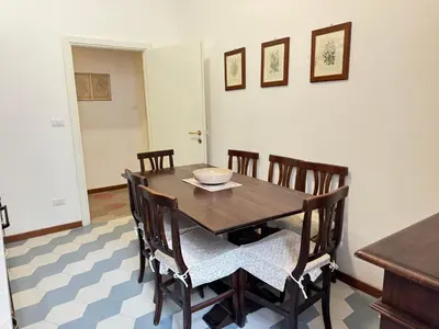 a dining room with a wooden table and chairs at Casa Angeli in Rome