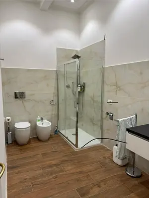 a bathroom with a shower and a toilet and a sink at Casa Angeli in Rome