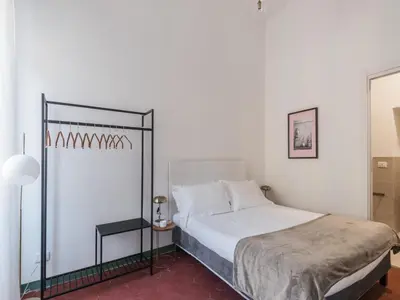 a bedroom with a bed with a black and white bed frame at The Best Rent - Two-bedroom apartment in Santa Maria Maggiore in Rome