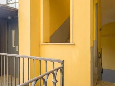a yellow wall with a window and a door at The Best Rent - Two-bedroom apartment in Santa Maria Maggiore in Rome