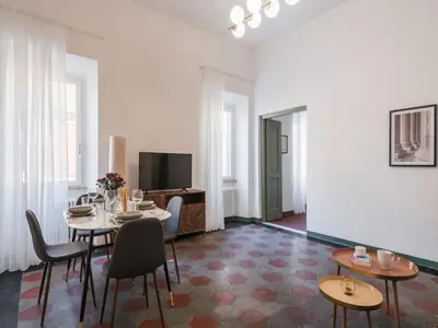 a living room with a table and chairs and a television at The Best Rent - Two-bedroom apartment in Santa Maria Maggiore in Rome