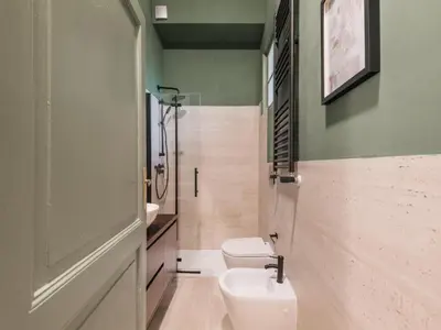 a bathroom with a toilet and a sink at The Best Rent - Two-bedroom apartment in Santa Maria Maggiore in Rome