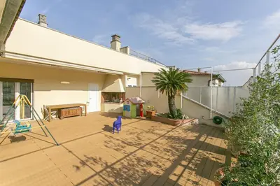 a child is standing on a patio of a house at Luxe Vatican Penthouse in Rome