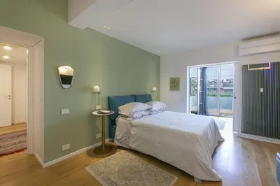 a bedroom with a bed and a large window at Luxe Vatican Penthouse in Rome