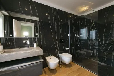 a bathroom with a sink and a toilet and a shower at Luxe Vatican Penthouse in Rome