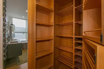 a walk in closet with wooden shelves and a window at Luxe Vatican Penthouse in Rome