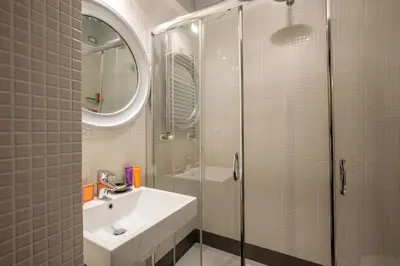 a bathroom with a sink and a glass shower at The Inn at the Spanish Steps Luxury Collection - Bocca di Leone 63 Luxury Suites in Rome