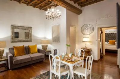 a living room with a couch and a table at The Inn at the Spanish Steps Luxury Collection - Bocca di Leone 63 Luxury Suites in Rome