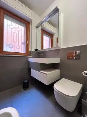 a bathroom with a sink and a toilet and a mirror at Premium Apartment Papillo in Rome