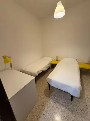 a room with two beds and a desk and a lamp at Domus Romae Caffarella in Rome