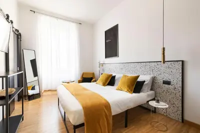 a bedroom with a large bed with yellow pillows at YCH-Charming home near San Giovanni in Rome