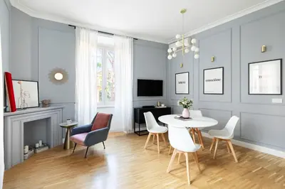 a living room with a table and chairs and a tv at YCH-Charming home near San Giovanni in Rome