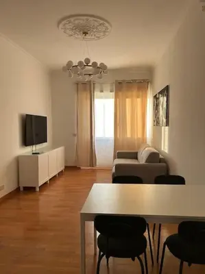 a living room with a couch and a table with chairs at A casa di Leo in Rome