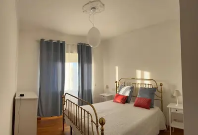a bedroom with a bed with red pillows on it at A casa di Leo in Rome