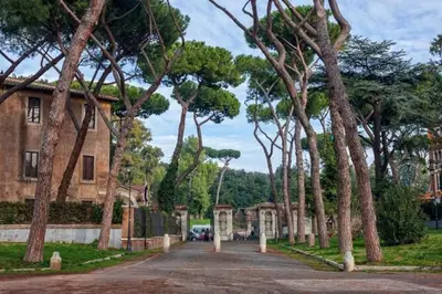 a road in front of a house with trees at Appartamento moderno a due passi dal Colosseo in Rome