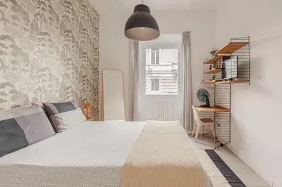 a bedroom with a large bed and a desk at Appartamento moderno a due passi dal Colosseo in Rome