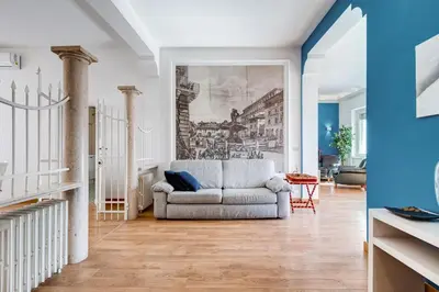 a living room with a couch and a painting on the wall at Chigi's Terrace in Rome