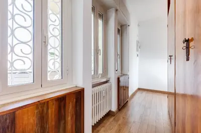 a hallway with white walls and a window at Chigi's Terrace in Rome