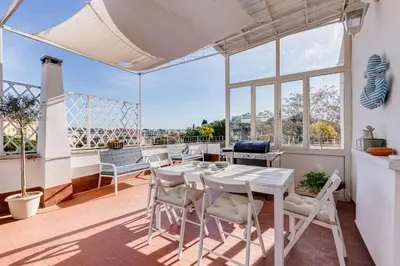 a room with a table and chairs on a balcony at Chigi's Terrace in Rome