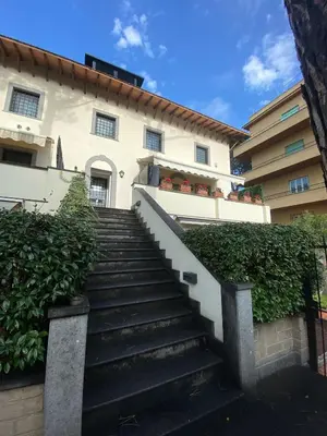 a stairway leading up to a white building at Gemelli Flower's House in Rome