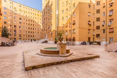 a fountain in the middle of a courtyard with tall buildings at Alloggio Chigi in Rome