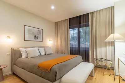 a hotel room with a large bed and a table at Villa Borghese Apartment in Rome