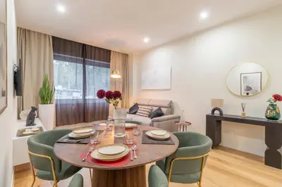 a dining room and living room with a table and chairs at Villa Borghese Apartment in Rome